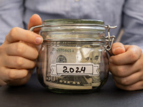 woman's hands holding jar of money